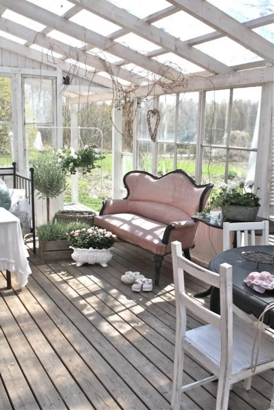Wintergarten zum Kuscheln rosa Couch Tisch grüne Topfpflanzen einfache Einrichtung angenehme Atmosphäre