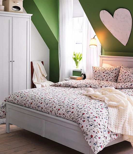 Frühlingsdeko Ideen fürs Schlafzimmer geblümte Bettwäsche feines Muster großes Herz an der Wand Vase mit weißen Blumen gemütliche und romantische Atmosphäre