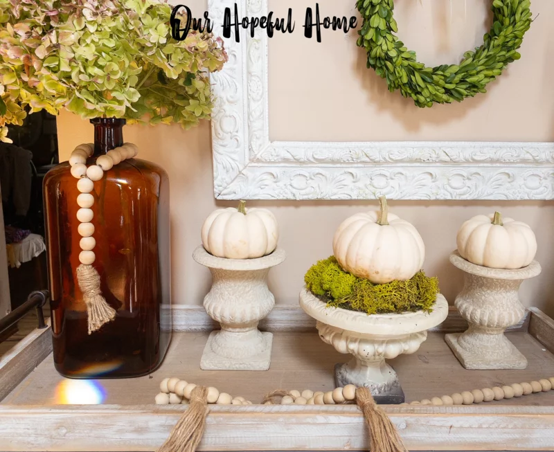 white pumpkins in French urns with moss